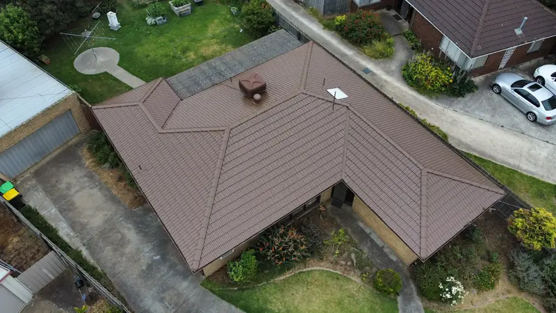 Brown tile roof on a hip and valley home, aerial view