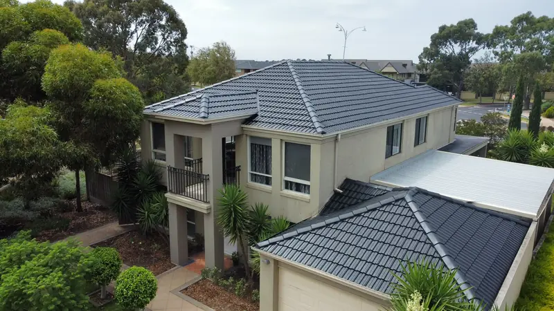 Two-storey home with a freshly painted charcoal tile roof
