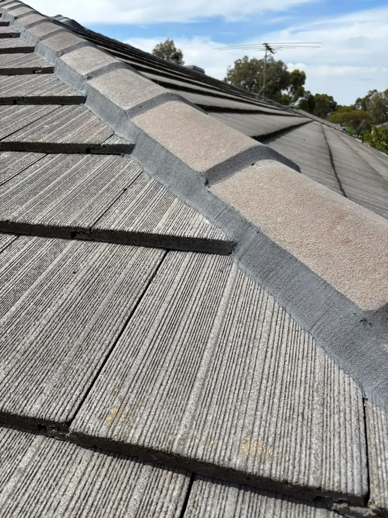 Ridge capping line on a grey concrete tile roof