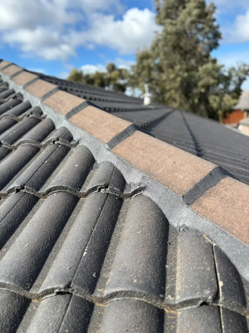 Close-up of newly pointed ridge capping on a grey tile roof