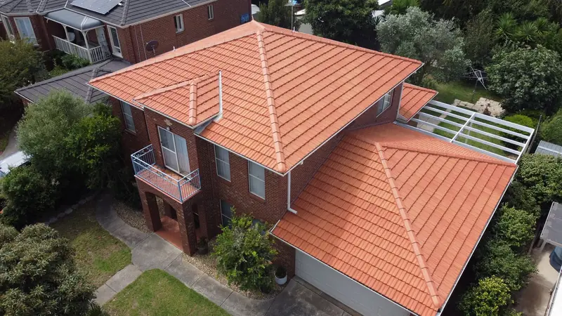 Restored terracotta tile roof on a two-storey brick home, seen from above