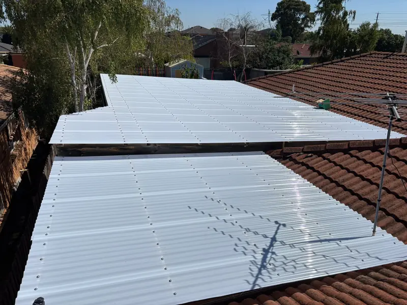 New white roof sheeting fitted over two patio roofs